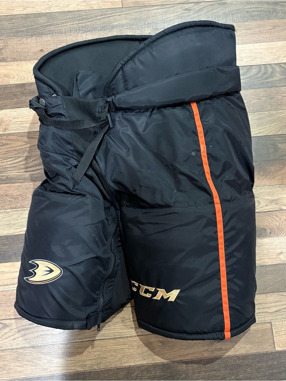 Large CCM HP70 Black Hockey Pants with Orange Stripe and Gold Accents
